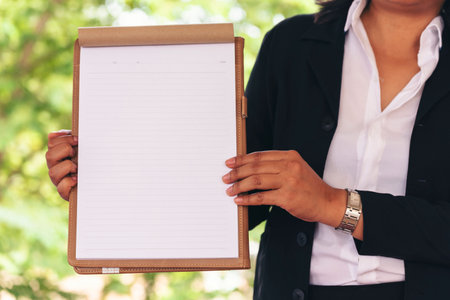 Businesswoman hands note document. Hands writing on empty notebook. Woman planning working on eco sustainable outdoors. Female hand holding pencil write on blank sketchbook. Mock-up Conceptの写真素材