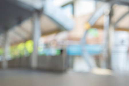 Blurry off white Backdrop hospital bright softness hotel with copy space. White Blurred background bright restaurant shopping mall Silver gray lighting. defocused store light bokeh in retail shopの写真素材