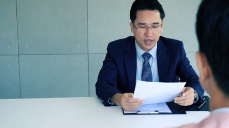 Businessman job interview by human resource HR officer interviwing, talk new employee shaking hands in office with smiling face. HR Manager interview check resume, face to face. Job Interview Conceptの写真素材