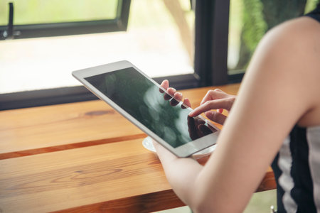 Woman hands using smartphone digital technology tablet empty blank screen. Close up Hands women holding smart tablet touch screen shopping online, call. Woman using mock up mobile at home officeの写真素材