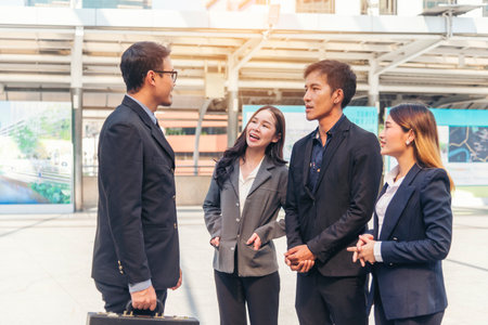 Diversity Business Partner meeting trust in teamwork and partnership businessman, businesswoman talking together in modern city. Asian coworker team meeting with Business People Working Together Teamの写真素材