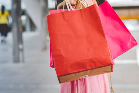 Shopaholic Women holding shopping bags ,money ,credit card person at shopping malls.Fashionable Woman love online website with sales tag on black Friday. E-commerce fashion digital marketing lifestyleの写真素材