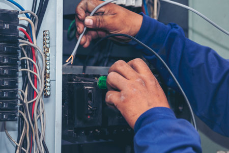 Electrical mechanic technician check wire electric cabinet. Inspector men hands working switchboard...