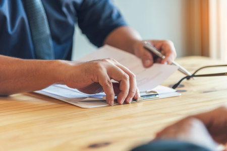 Businessman hands note meeting document in conference room. man Hands writing planning notebook. Close up male hand holding pencil write on diary sketchbook at office desk. Business Planning Conceptの写真素材