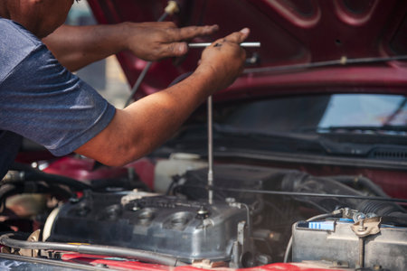 Close up Man hands fixing Car machinery vehicle mechanical service. Mechanic man hands repairing car...
