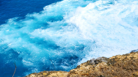 Turquoise ocean sea water white wave pattern splashing deep blue sea. Seascape dark ocean background...