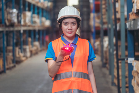 Portrait warehouse women using bar code reader scan goods products on inventory shelf. Asian women worker check stock inventory. Logistics staff counting products store inventory storage distributionの写真素材