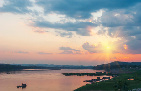 Silhouette tranquil season wilderness serene landscape. Tranquil lake countryside sunrise seaside reflection. Tropical amazing dramatic golden sky on sunset over scenic river lake seascape ocean.の写真素材