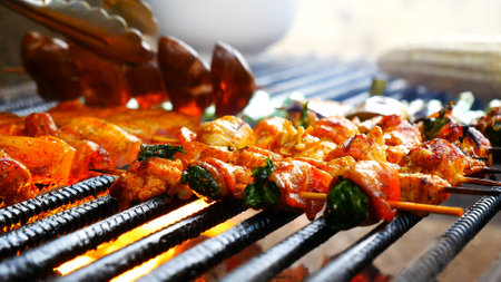 BBQ Barbecue grilled meat stick on fire flame with hot charcoal cooking outside. Beef grilling...