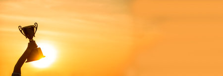 Banner Winner win hands holding golden champion trophy cup prize. Silhouette best award victory hands champion trophy . Panorama Team holding gold sport trophy cup. Win-Win sport team with copy spaceの写真素材