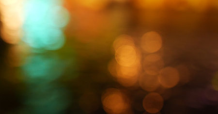 Colorful Bokeh abstract blurred background music festival stage show performance party. Vibrant bokeh background spark animate motion. Backdrop display with twinkling night life shape blinking lightの写真素材