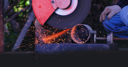 Welding machinery iron metal sparking equipment. Hot flame welding metal work cutting fire iron workshop. Locksmith using Welding machine cutting metal process grinder. Heavy Engineer metalworkingの写真素材