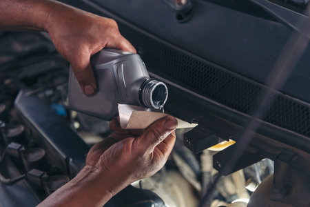 Close up Man hands fixing Car machinery vehicle mechanical service. Mechanic man hands repairing car auto repair shop. open vehicle hood checking up auto mobile. Vehicle Car maintenance engineer.の写真素材