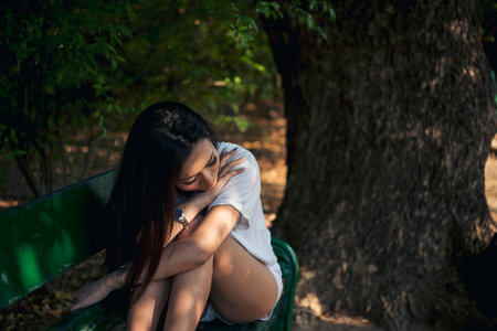 Recession Stress Woman using laptop work hard at home office outdoor in green park. Young women have headache, depressed from failure business burnout. Tired Asian woman despair sadness problemsの写真素材