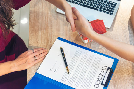 Close up Diversity Businesswoman teams handshake together. Partnership teamwork meeting signing contract business concept. Team Businesswoman hands partners sign contract with success business dealの写真素材