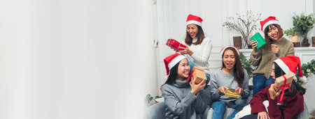 Banner Group of Asian Woman party exchange christmas gift box xmas tree surprise present. Women holding gift box sitting living room celebrate christmas xmas holiday winter festival with copy spaceの写真素材