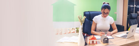 Banner Businesswoman selling house real estate agent at office desk. Women working home insurance mortgage banking document. Banner Asian women dealership real estate rental home with copy spaceの写真素材