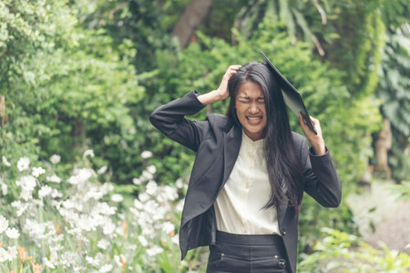Desperate Asian woman stress headache depressed from startup small business at home office. Failure business woman work at home office. Online seller entrepreneur has problem delivery unhappy jobの写真素材