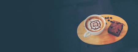 Banner Coffee barista pour espresso shot and make latte art hot coffee cup. Cappuccino with milk in italian coffee shop cafe. Banner Close up hands of barista make brown latte art with copy spaceの写真素材
