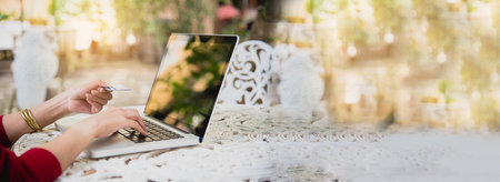 Banner Woman typing laptop computer online meeting at home office work from home. Asian businesswoman use notebook laptop. Programmer woman typing keyboard laptop read online website with copy spaceの写真素材