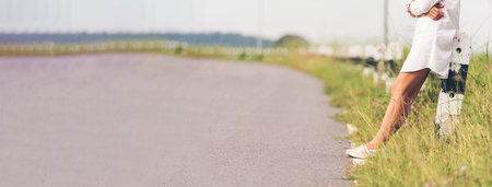 Banner Woman traveller walking on road relaxation. Women wear sneaker shoes walking summer park. Females standing green park on forest pathway outdoors. Traveler relaxing walk way with copy spaceの写真素材