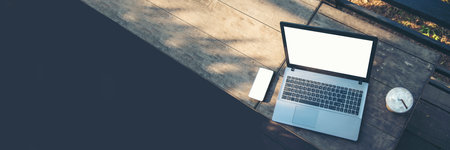 Banner Top view office desk laptop and coffee cup on wood table copy space.  Panorama tabletop notebook laptop coffee cup for officer display empty space wooden background workspace full banner designの写真素材