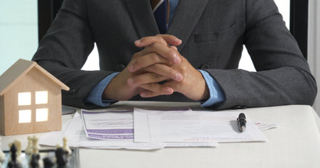 Businessman real estate house agent teamwork discuss team businessperson. Team partner man women selling house real estate agent at office desk. Team working home insurance mortgage sale apartmentの写真素材