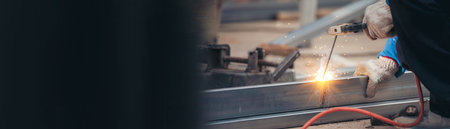 Banner Men hands wear protective glove Hot flame metal work cut fire iron workshop. Locksmith cut metal process. Construction Worker hands using Welding machinery iron metal sparking with copy spaceの写真素材