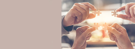 Banner Implement puzzle improve hand holding together solve synergy organize team connection plan trust strategy. Stakeholder business trust teams hands holding jigsaw puzzle synergy with copy spaceの写真素材