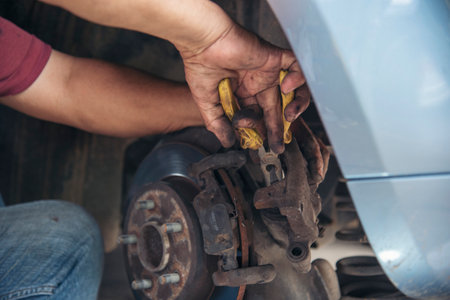 Close up Man hands fixing Car machinery vehicle mechanical service. Mechanic man hands repairing car auto repair shop. open vehicle hood checking up auto mobile. Vehicle Car maintenance engineer.の写真素材