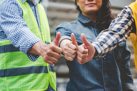 Group of multiracial people Teamwork meeting join hands Engineer Manager Foreman fist bump together. Close up diversity engineer people hands partner teams. Business connection team join partnershipの写真素材