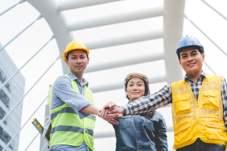 Group of multiracial people Teamwork meeting join hands Engineer Manager Foreman fist bump together. Close up diversity engineer people hands partner teams. Business connection team join partnershipの写真素材