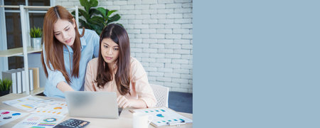 Banner Happy success business woman partner meeting working together in company office. Panoramic picture of Meeting Executive Asian business woman office desk with fist arm raised executive teamworkの写真素材