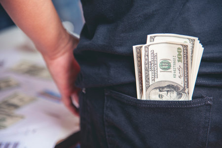 Hand holding money dollar bank note in wallet give financial payment. Man hands showing spread 100 dollar exchange cash payout. Saving Businessman counting money banknote concept.の写真素材