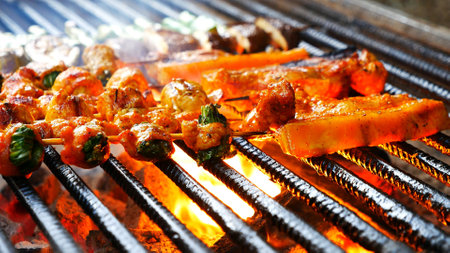 BBQ Barbecue grilled meat stick on fire flame with hot charcoal cooking outside. Beef grilling picnic outdoor with smoke bacon spicy sausage for party. Grill pork bbq on fire flameの写真素材