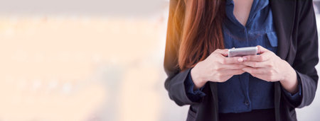 Banner Women sitting on sofa using smartphone, credit card to shopping online with smiling face. Panorama Happy asian women lay down use smartphone. Woman online shopping with copy spaceの写真素材