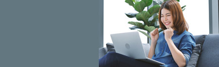 Banner Woman typing laptop computer online meeting at home office work from home. Asian businesswoman use notebook laptop. Programmer woman typing keyboard laptop read online website with copy spaceの写真素材