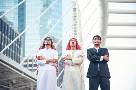 Arab team hold digital tablet uae union teamwork people. Digital marketing arab group of people using smart tablet discuss modern muslim UAE city. Entrepreneur Asian people smile teams meeting.の写真素材