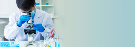 Banner Scientist man look Microscope research in science laboratory. Banner Asian scientist use microbiology microscope in laboratory equipment chemistry lab. Biochemistry experiment with copy spaceの写真素材
