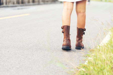 Woman traveller walking on road relaxation. Women wear sneaker shoes walking on summer park. Females standing in green park on forest pathway outdoors. Young traveler relaxing vacation in walk wayの写真素材