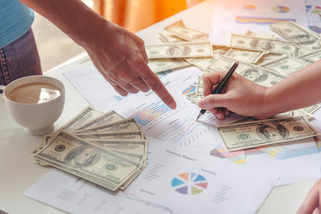 Close up hands giving money payment. Hands holding dollar bill financial economy business people. Business people try to pay. Corruption conceptの写真素材