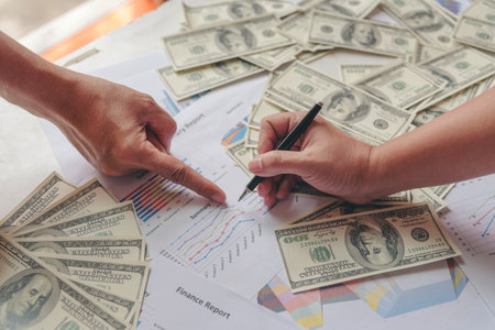 Close up hands giving money payment. Hands holding dollar bill financial economy business people. Business people try to pay. Corruption conceptの写真素材