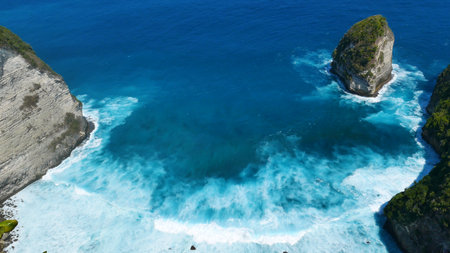 Turquoise ocean sea water white wave splashing deep blue sea. Bird eye view wave splash on rock. Tropical sea beach in summer seaside outdoor. Ocean island beautiful dramatic landscape.の写真素材
