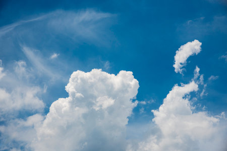 Blue sky fluffy white clouds on summer season bright clear skyline with beautiful cloudscape. Panorama blue sky clouds pattern on daylight with copy space. Cumulus cloudscape air climate sunny dayの写真素材