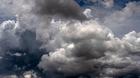Dramatic dark storm rain clouds black sky background. Dark thunderstorm clouds rainny atmosphere. Meteorology danger windstorm disasters climate. Dark cloudscape storm disaster gloomy gray cloud skyの写真素材
