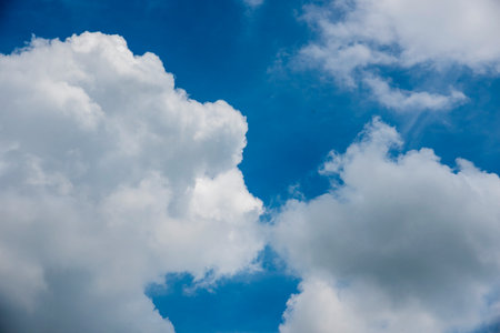 Blue sky fluffy white clouds on summer season bright clear skyline with beautiful cloudscape....