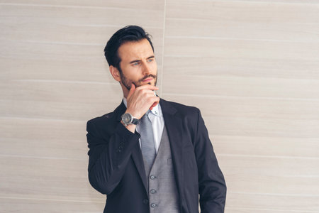 Portrait happiness caucasian businessman smiling face confident leader manager in meeting rooom office desk. Caucasian handsome man success look away thinking poses. Men standing in suit handsome CEOの写真素材