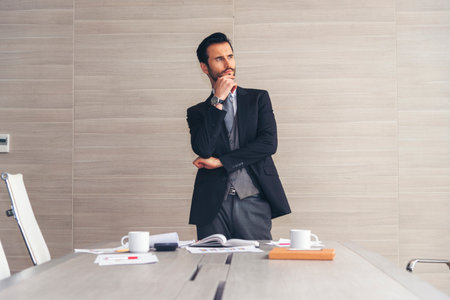 Portrait happiness caucasian businessman smiling face confident leader manager in meeting rooom office desk. Caucasian handsome man success look away thinking poses. Men standing in suit handsome CEOの写真素材