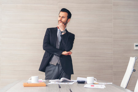 Portrait happiness caucasian businessman smiling face confident leader manager in meeting rooom office desk. Caucasian handsome man success look away thinking poses. Men standing in suit handsome CEOの写真素材