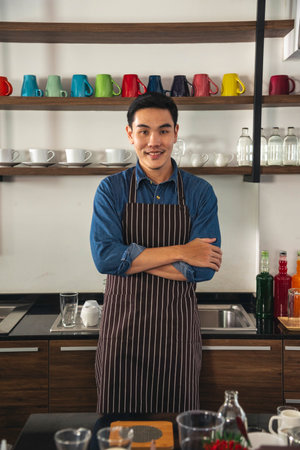 Portrait Barista small business Owner. Asian barista man coffee shop owner smiling look at camera small business confident person Entrepreneur manager professional men standing coffee counter barの写真素材